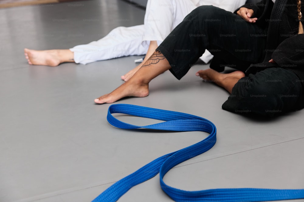 a person sitting on the floor with a blue leash