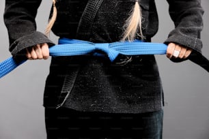 a woman holding a blue rope in her hands