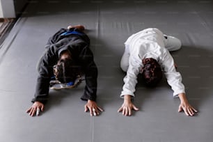 a person laying on the ground with their hands on the ground