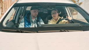 a man and a woman sitting in a car