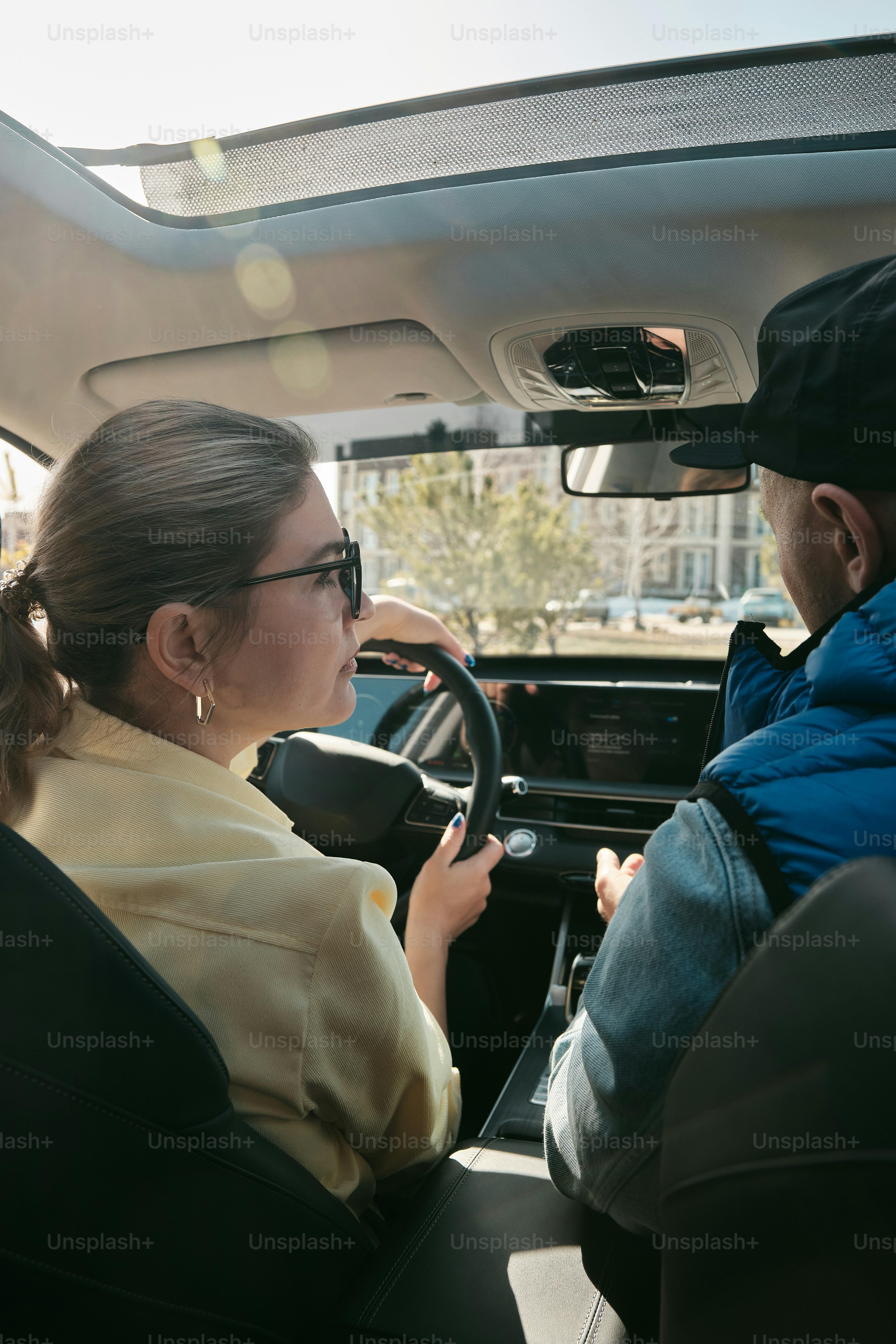 a man and a woman sitting in a car