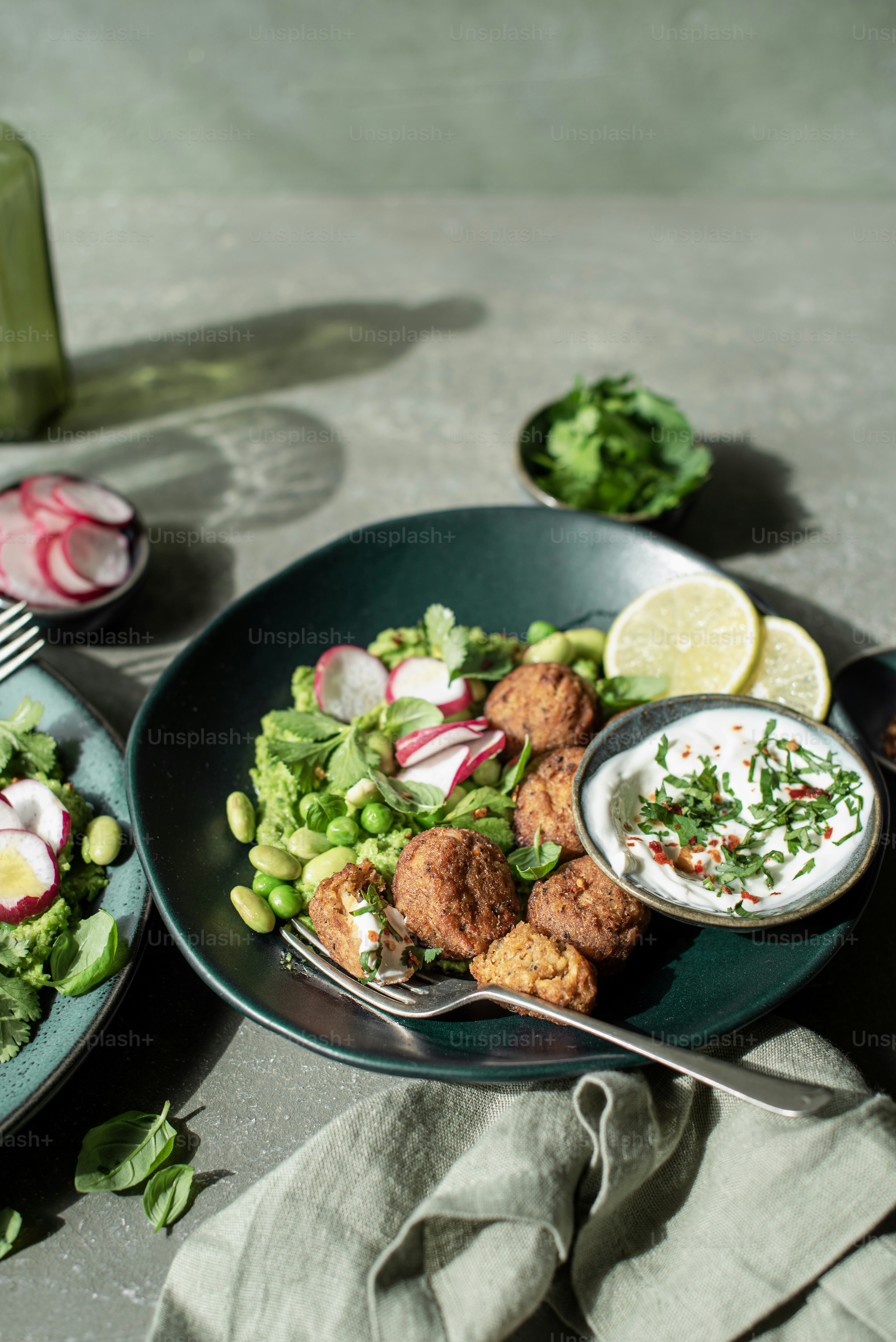 a plate of food on a table next to a bottle of wine