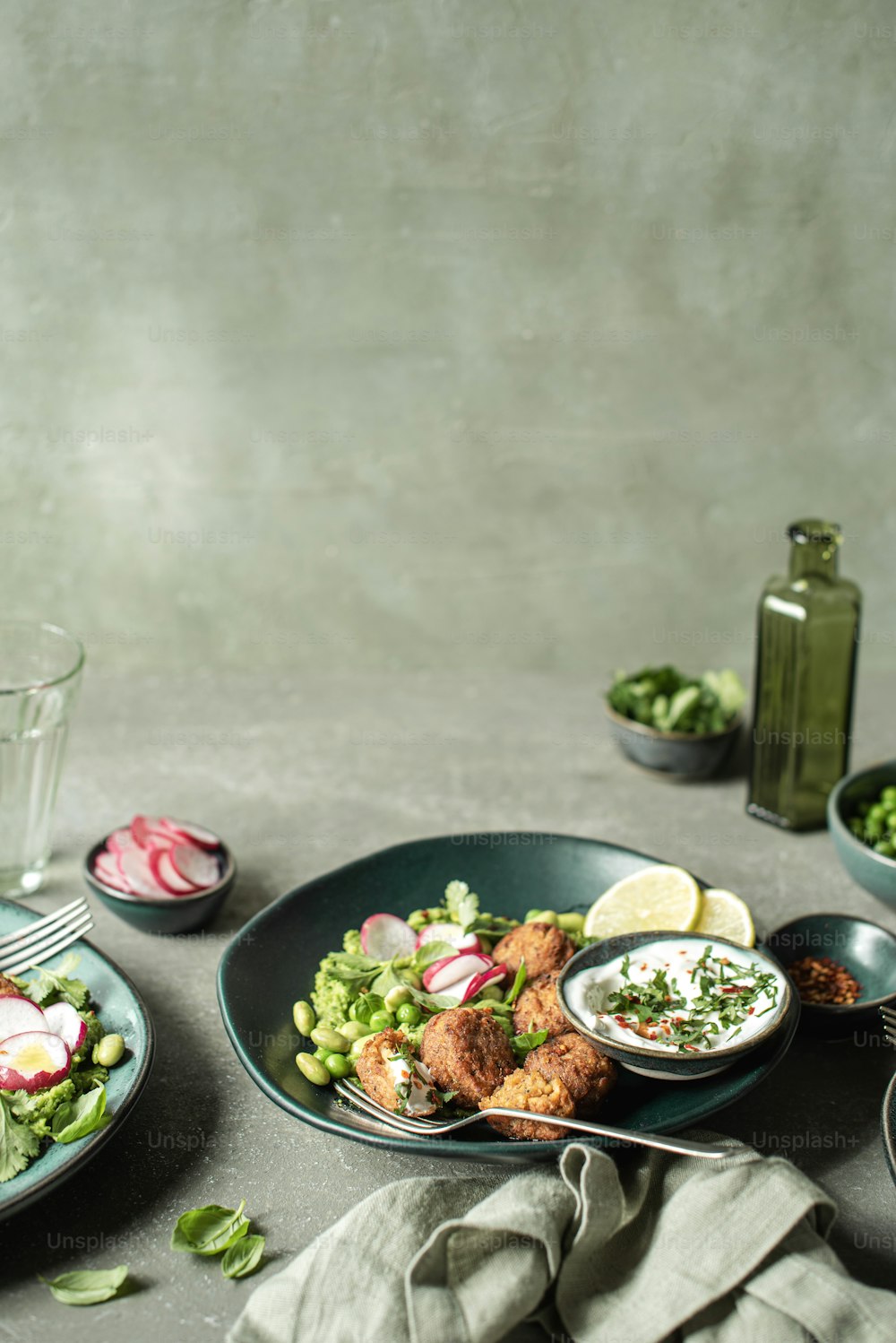 a table topped with plates and bowls of food