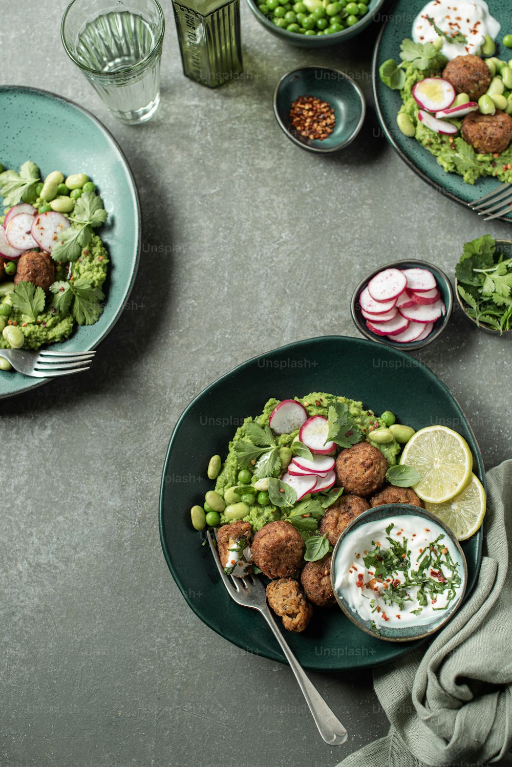 a table topped with plates of food and bowls of vegetables