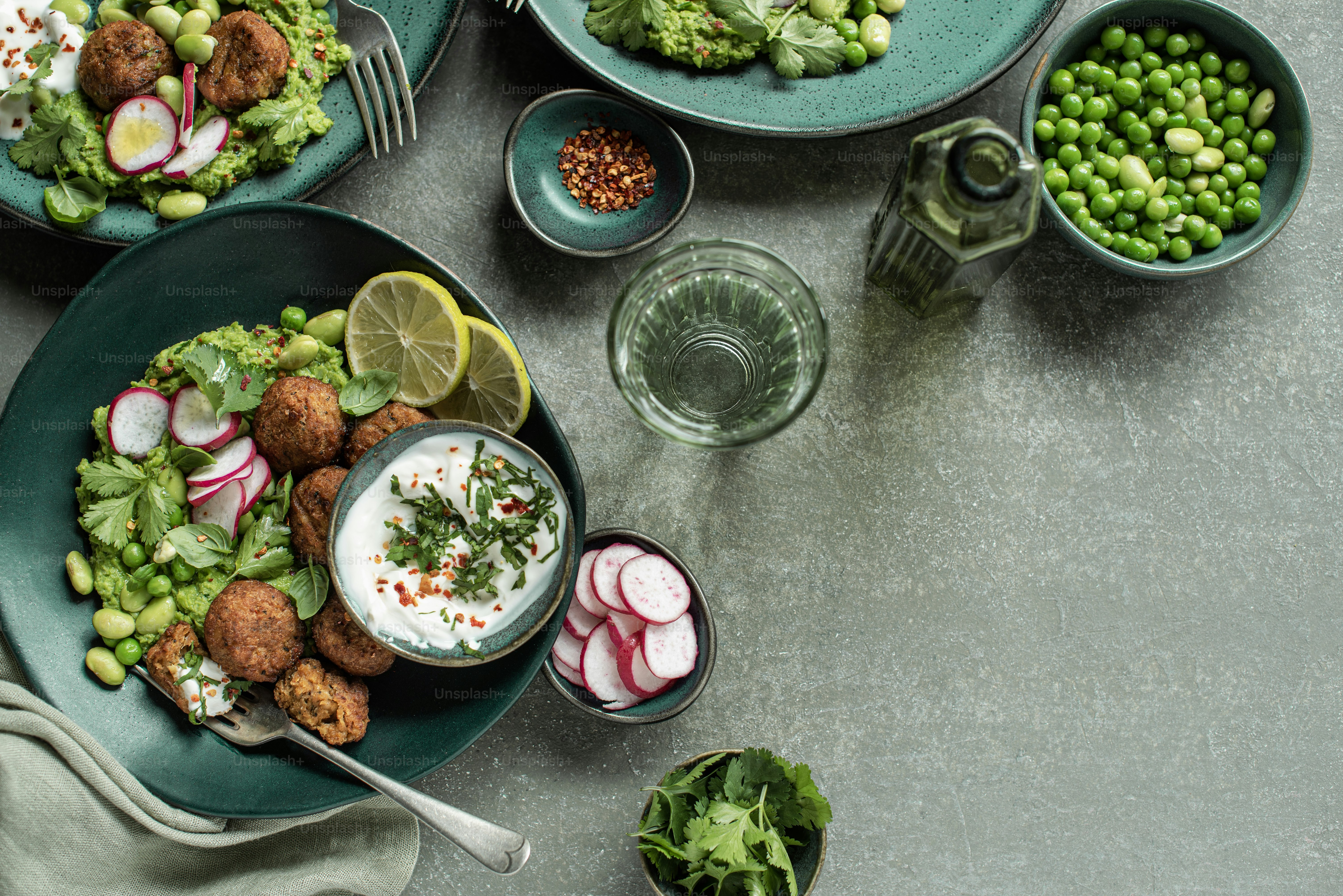 a table topped with plates of food and bowls of vegetables