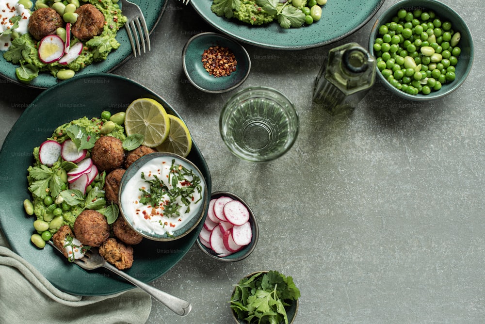 una mesa cubierta con platos de comida y cuencos de verduras