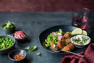 a plate of food on a table with a glass of water