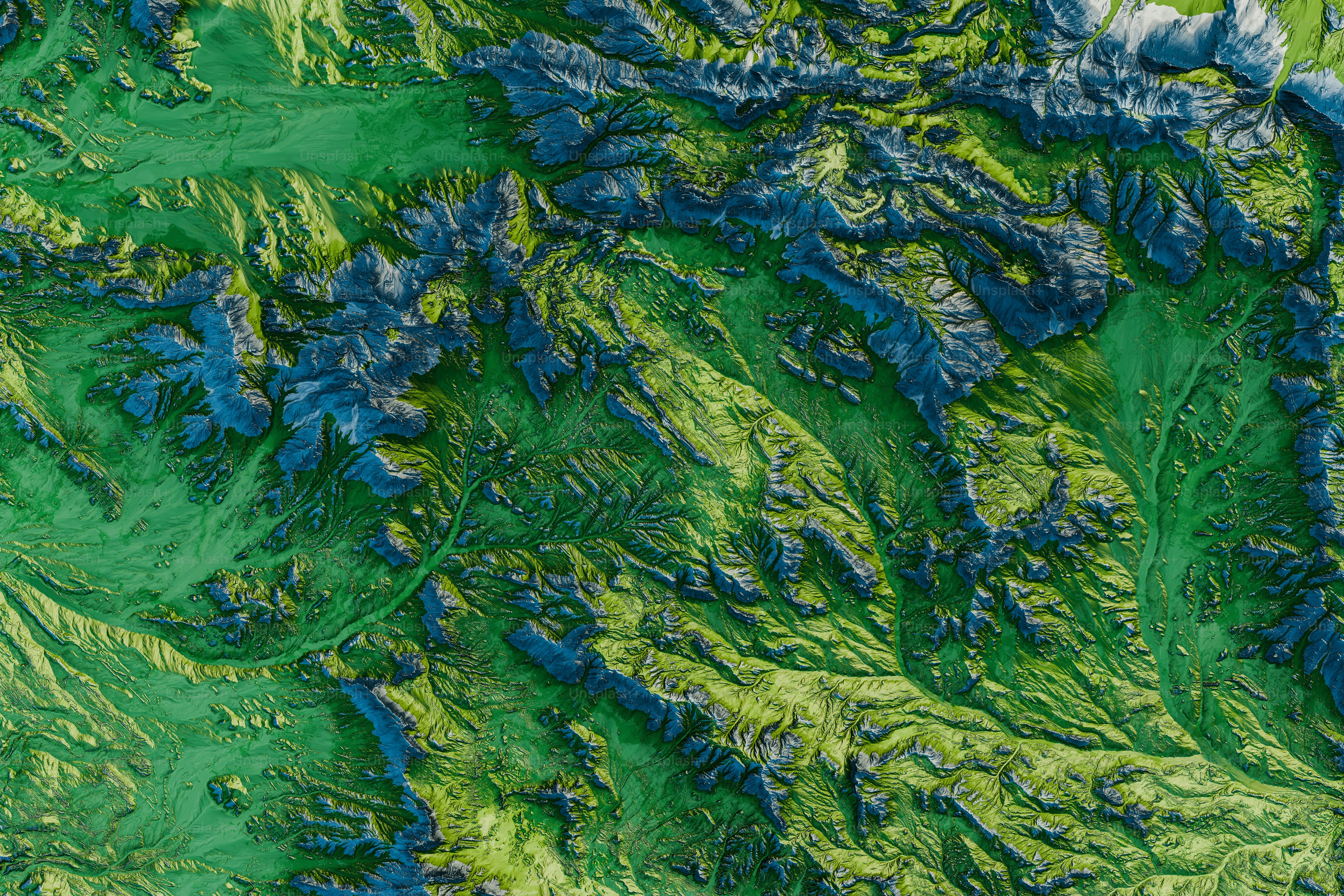 an aerial view of a green mountain range