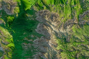 an aerial view of a green mountain range