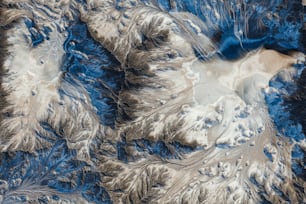 an aerial view of a snow covered mountain range