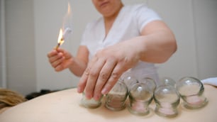 a woman holding a lit cigarette in her right hand