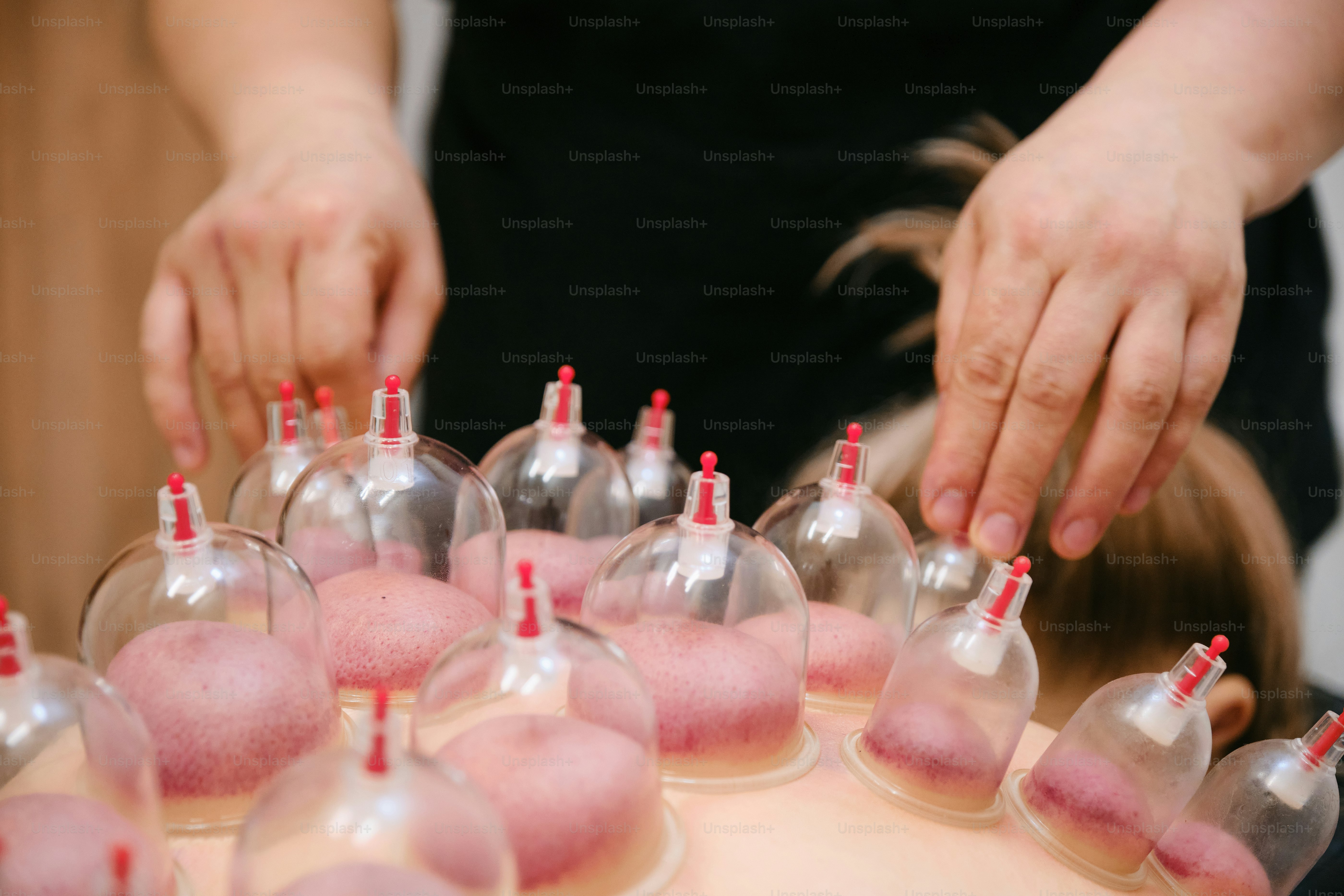 a table topped with lots of wine glasses filled with sand