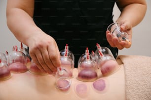 a woman getting a back massage with a lot of bottles