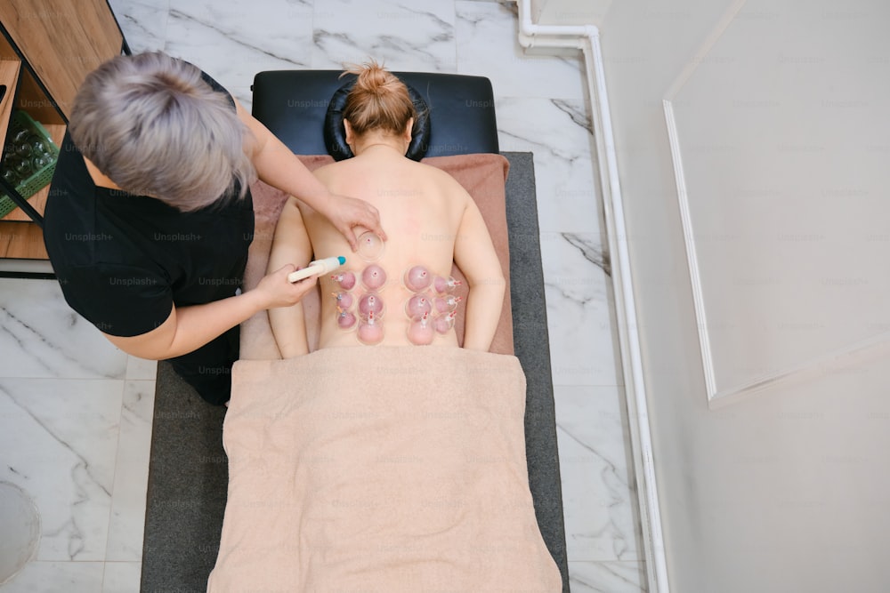 a woman getting a back massage with donuts on her back