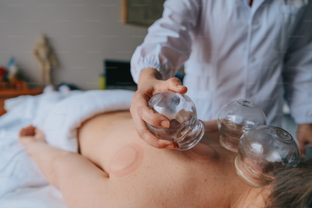 a woman getting a back massage with a bottle of water
