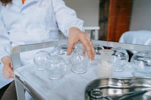 a person reaching for a glass on a tray