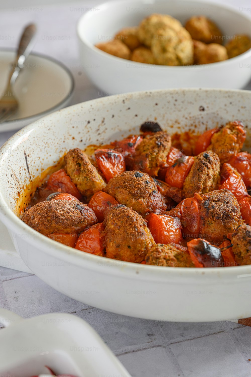 a dish of meatballs and tomato sauce on a table
