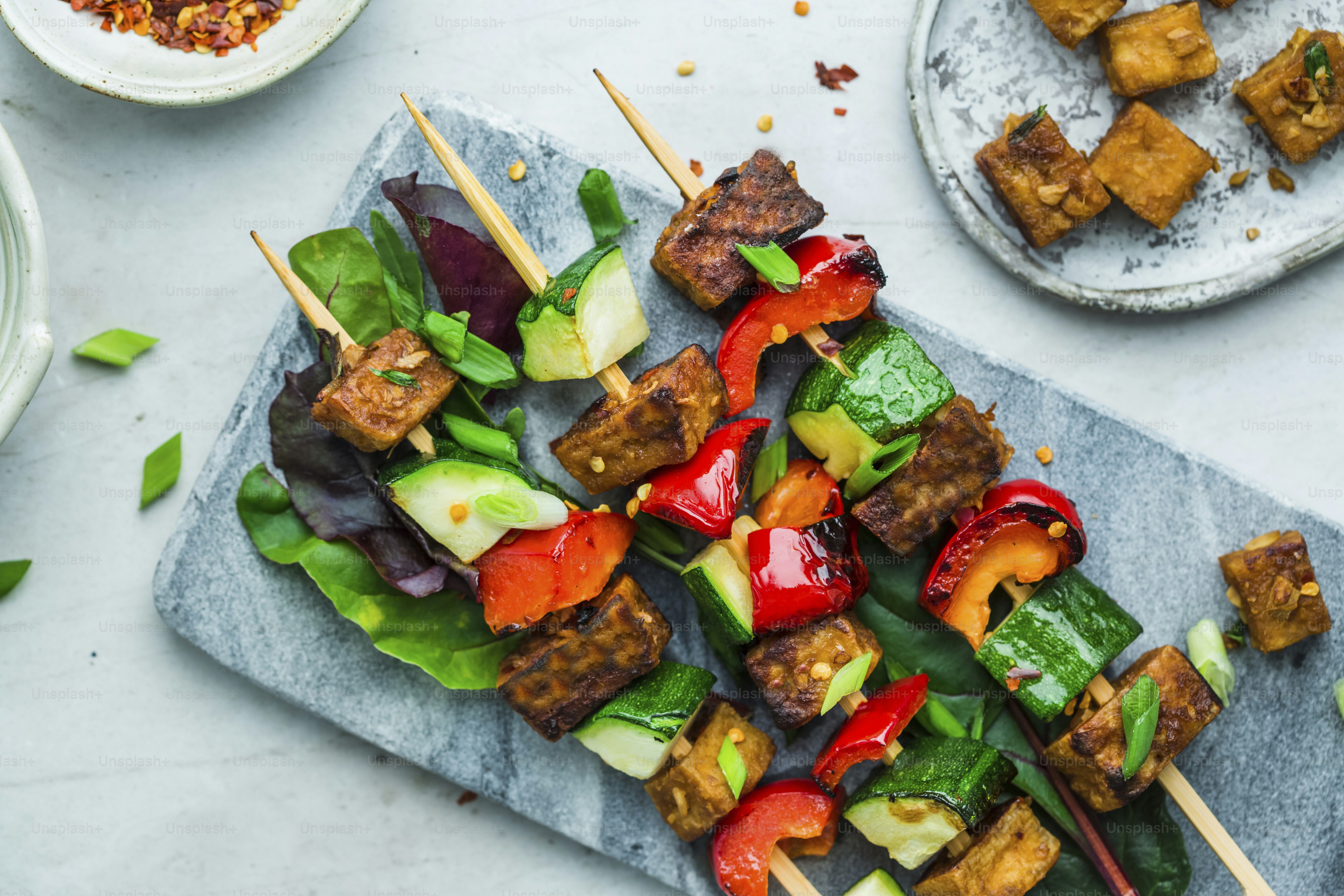 a plate of food that includes tofu and veggies