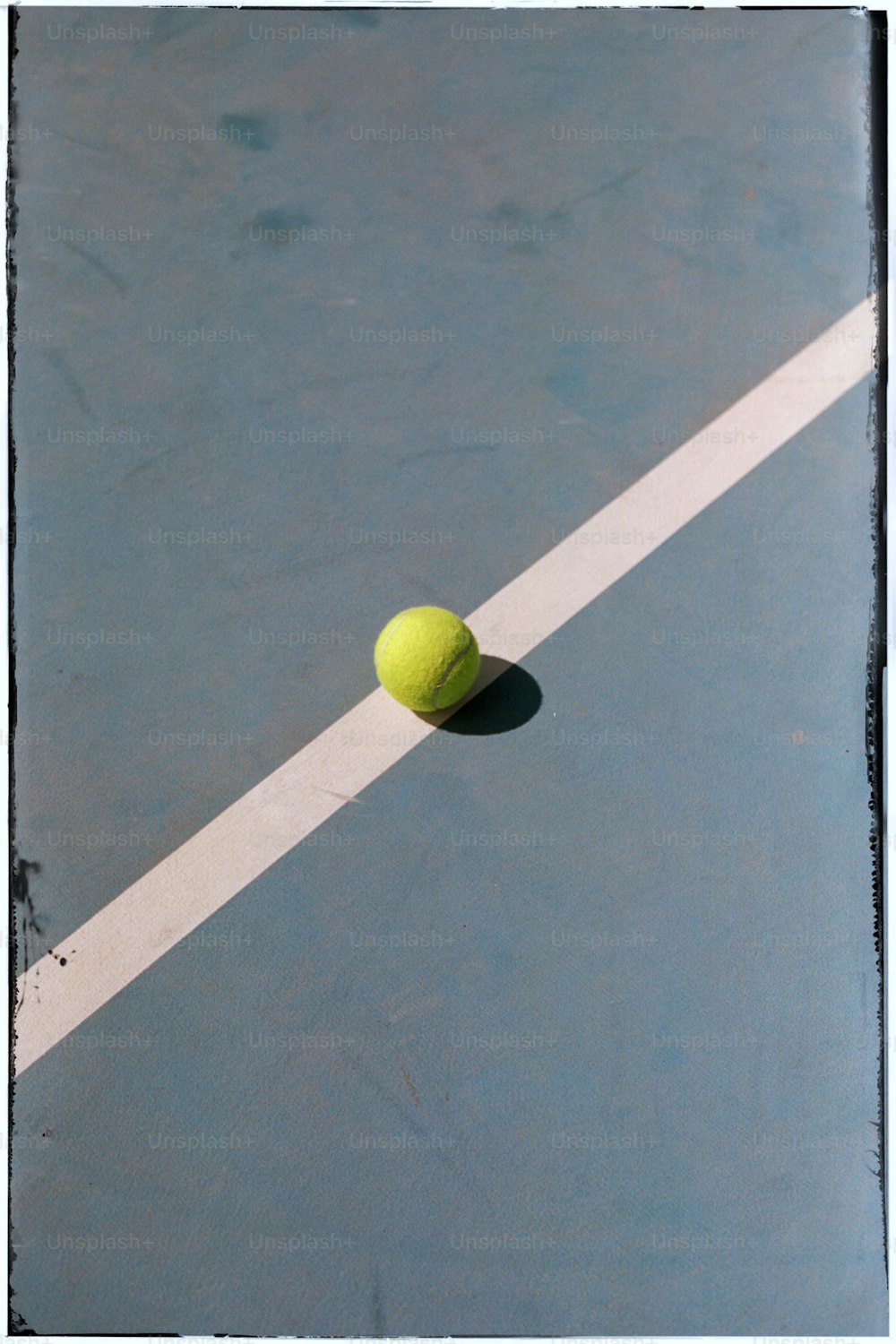 a tennis ball sitting on a tennis court