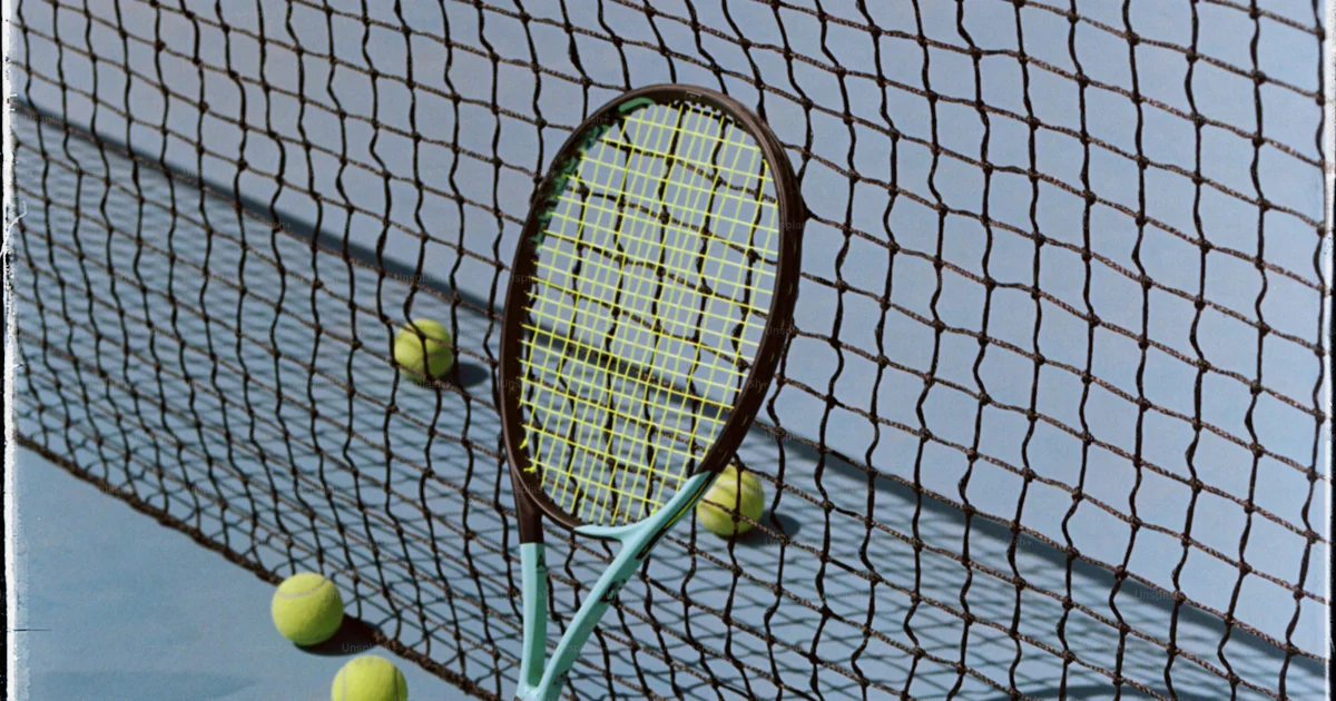 A tennis racket sticking out of the net photo – Film grain Image on ...