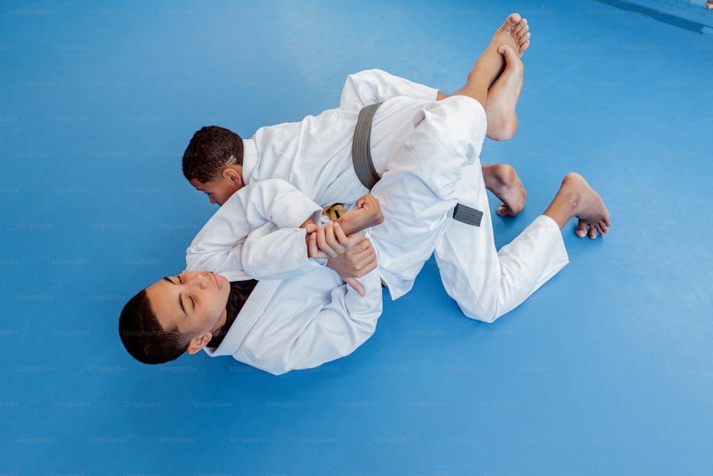 a man in a white shirt and a man in a black belt