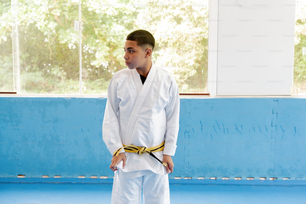 a young man in a white karate outfit
