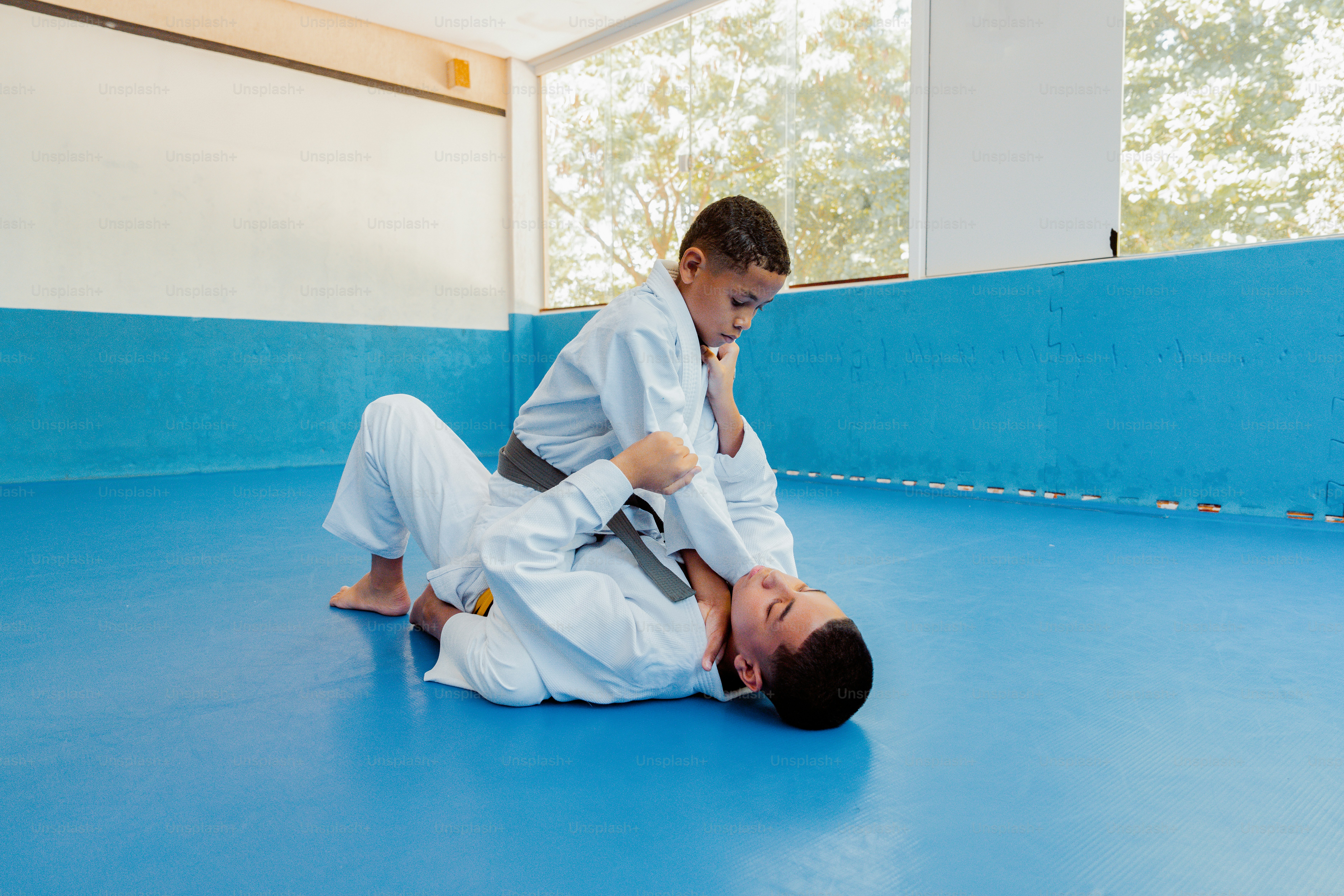 a young man in a white kimono and a young man in a black belt