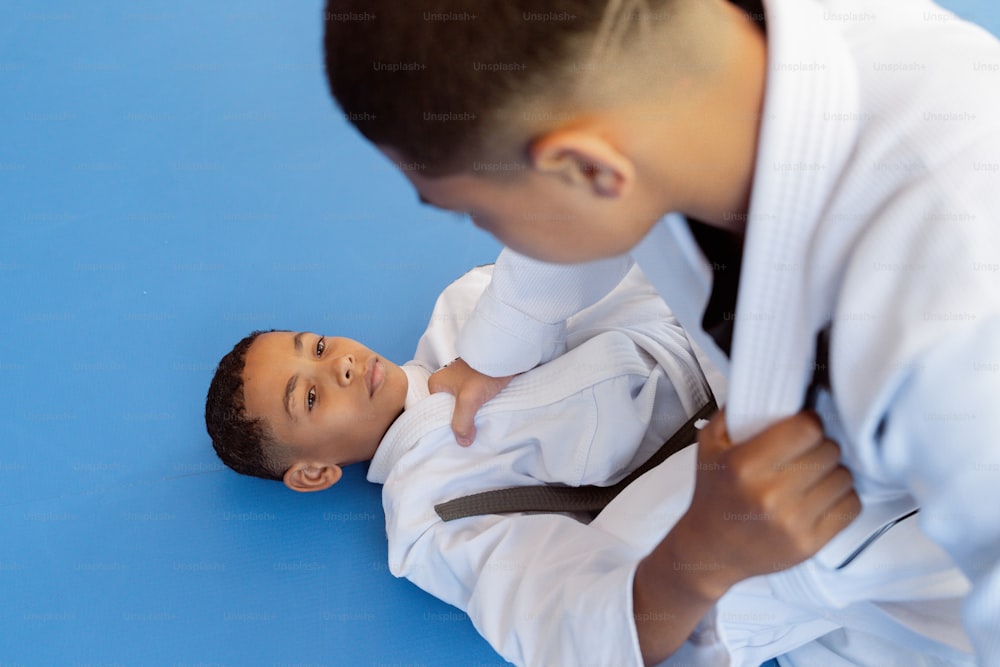a young boy is learning how to do a choke