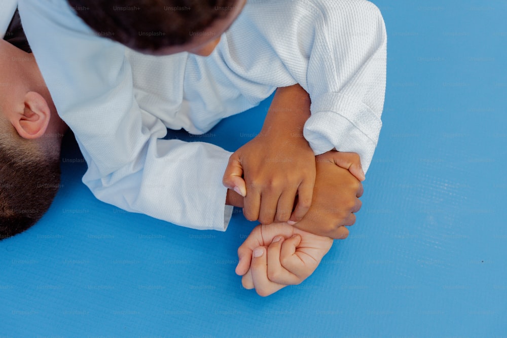 a young child is holding the hand of an adult