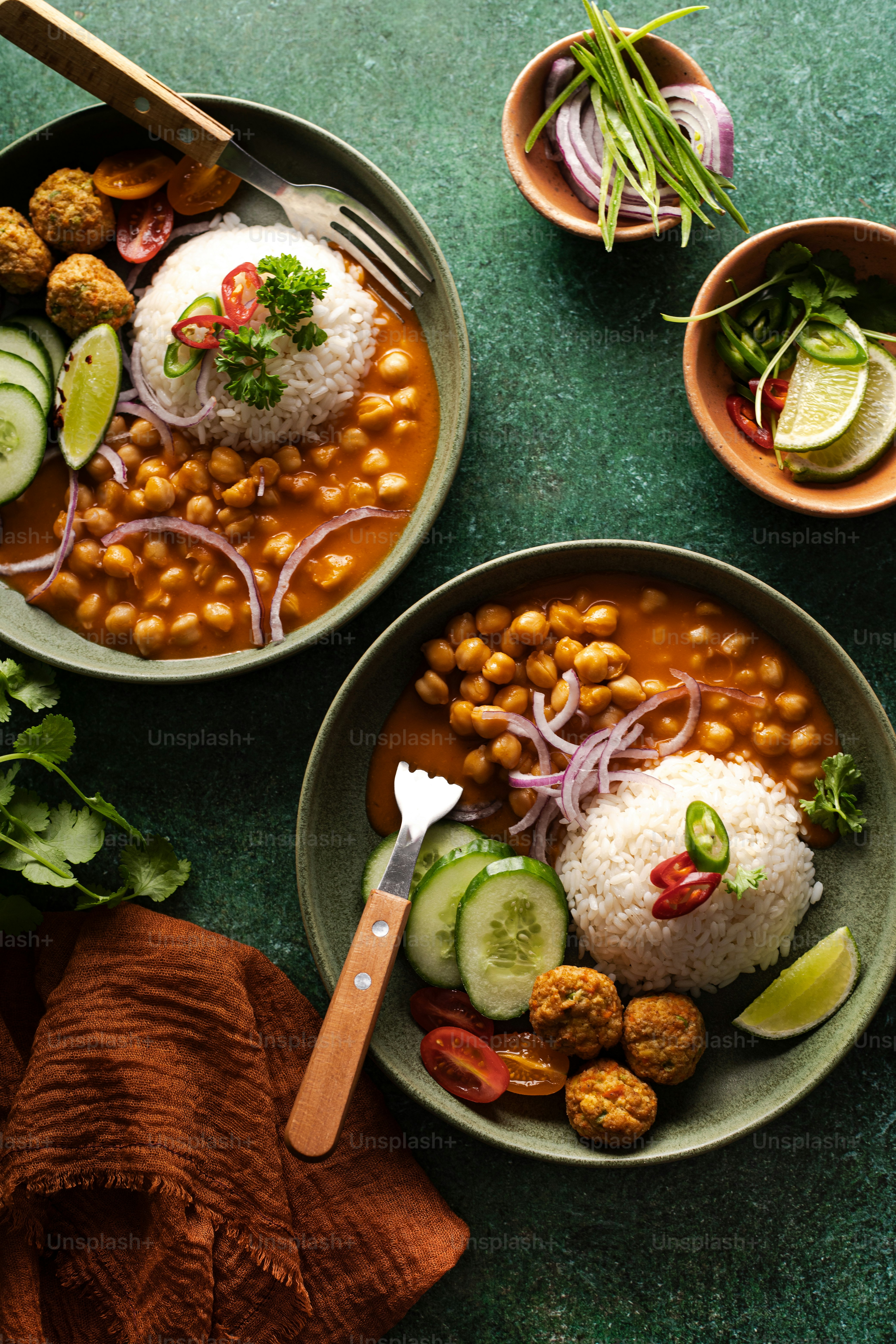 two bowls of food on a green table
