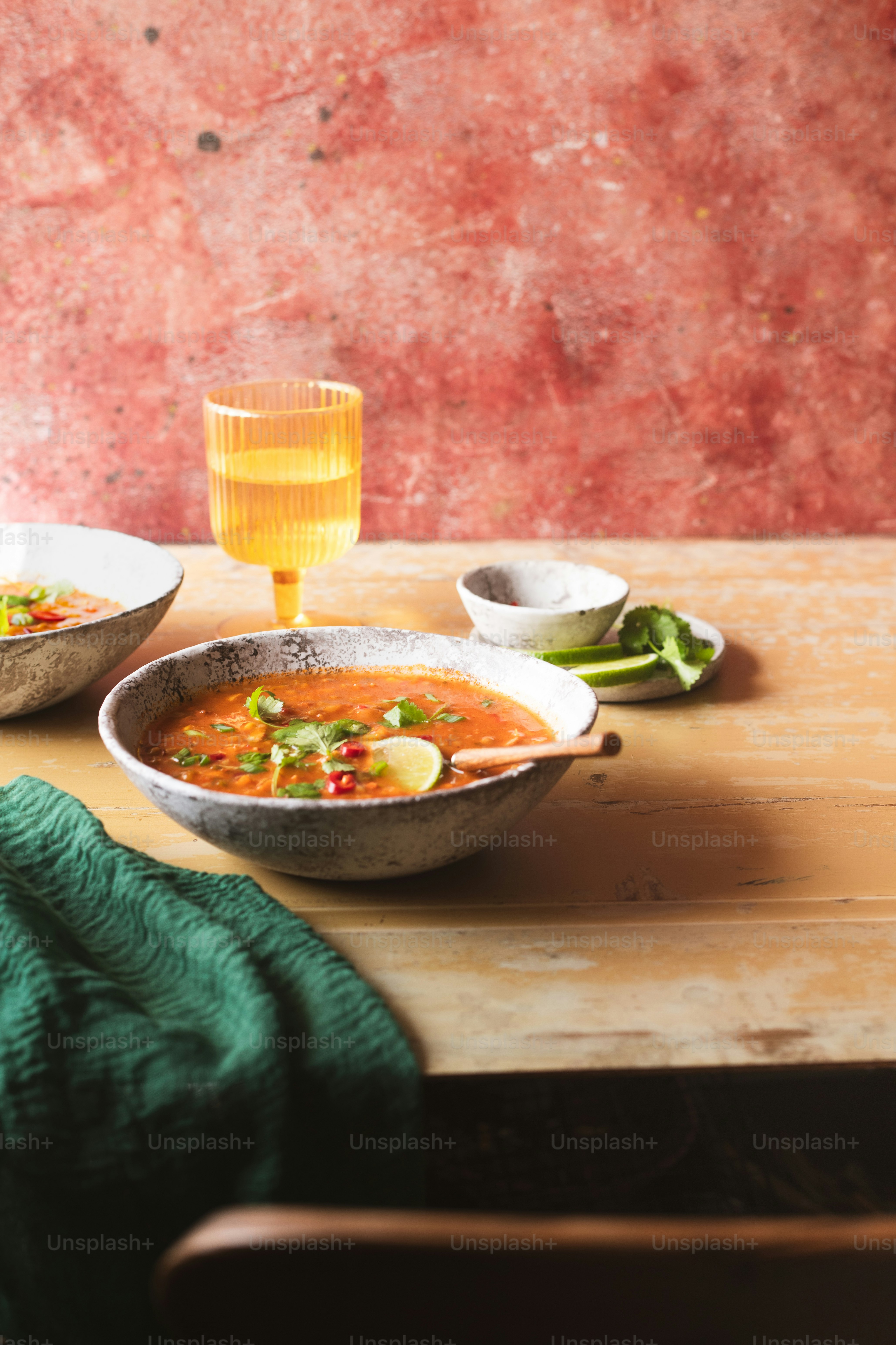 two bowls of soup on a wooden table