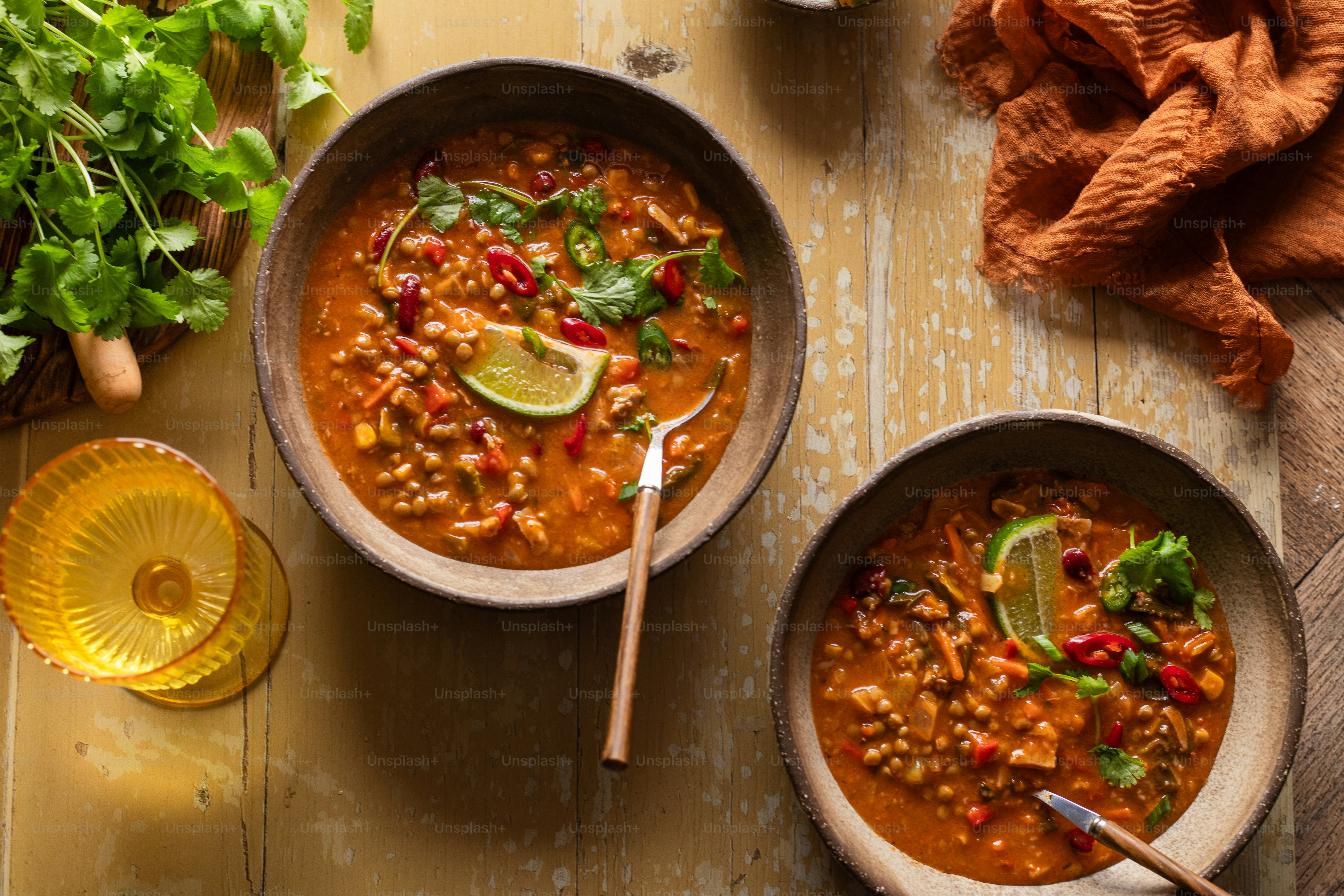 two bowls of soup on a wooden table