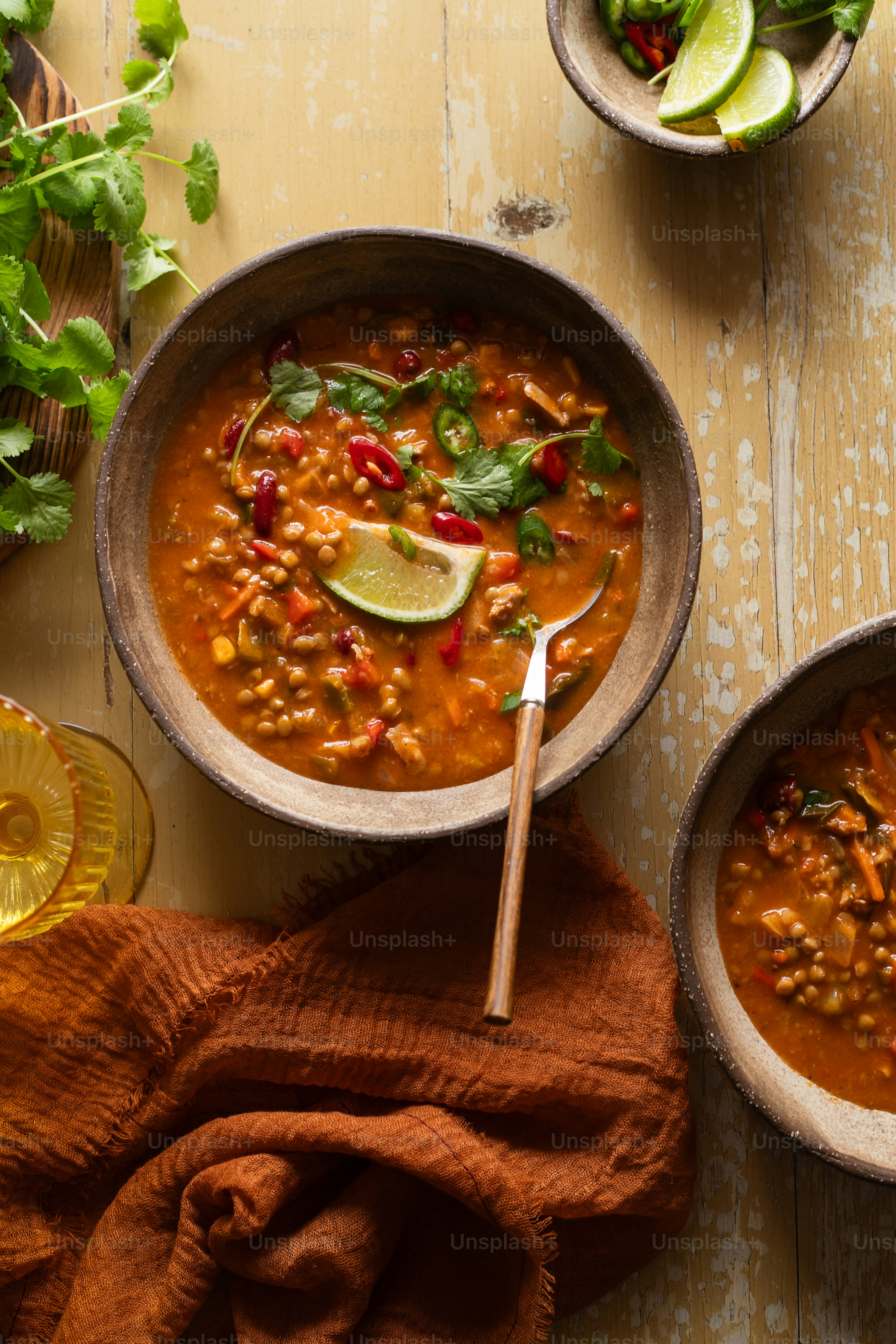 two bowls of soup on a wooden table