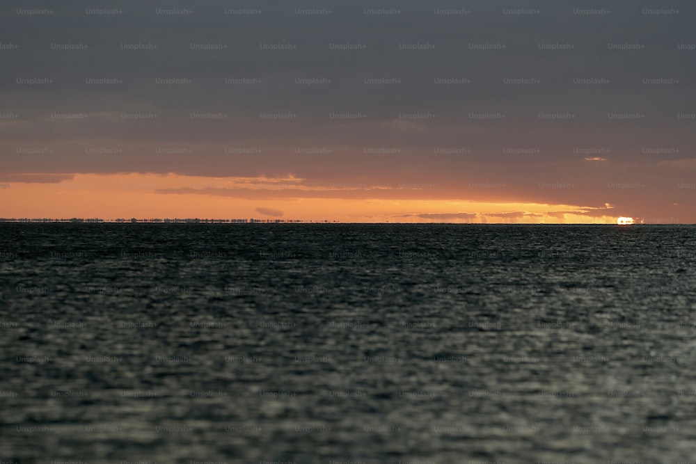 a large body of water under a cloudy sky