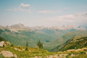 a scenic view of a mountain range with trees and mountains in the background