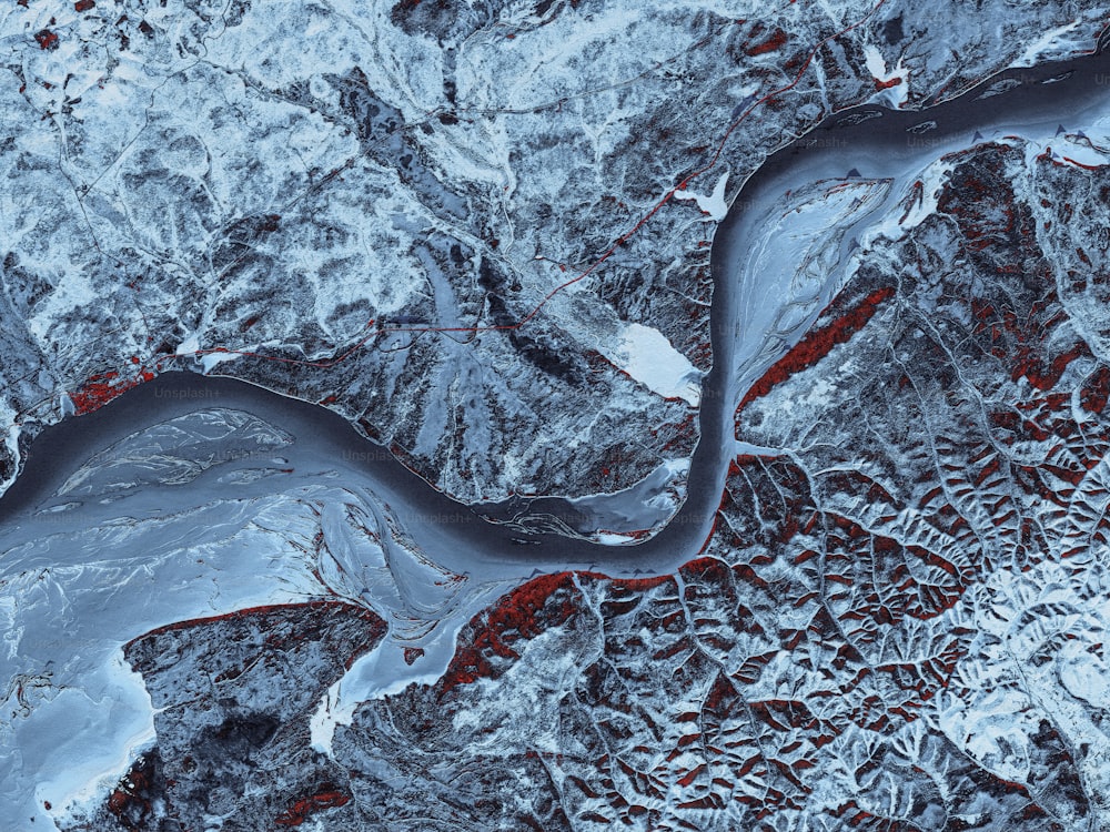 an aerial view of a river in the snow