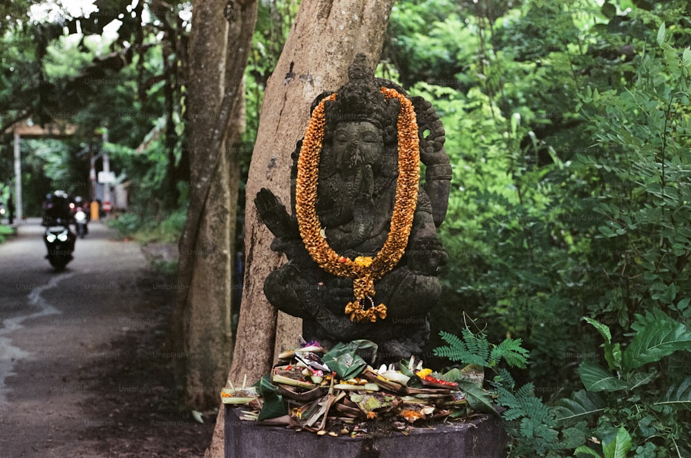a statue of a buddha in the middle of a forest