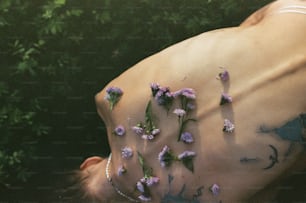 a man with flowers on his back