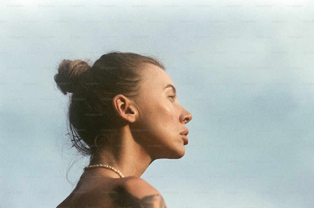 a woman with tattoos on her chest and neck