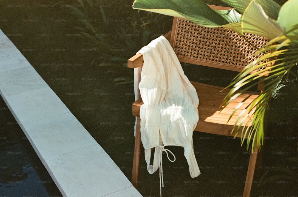 a wooden chair sitting next to a pool