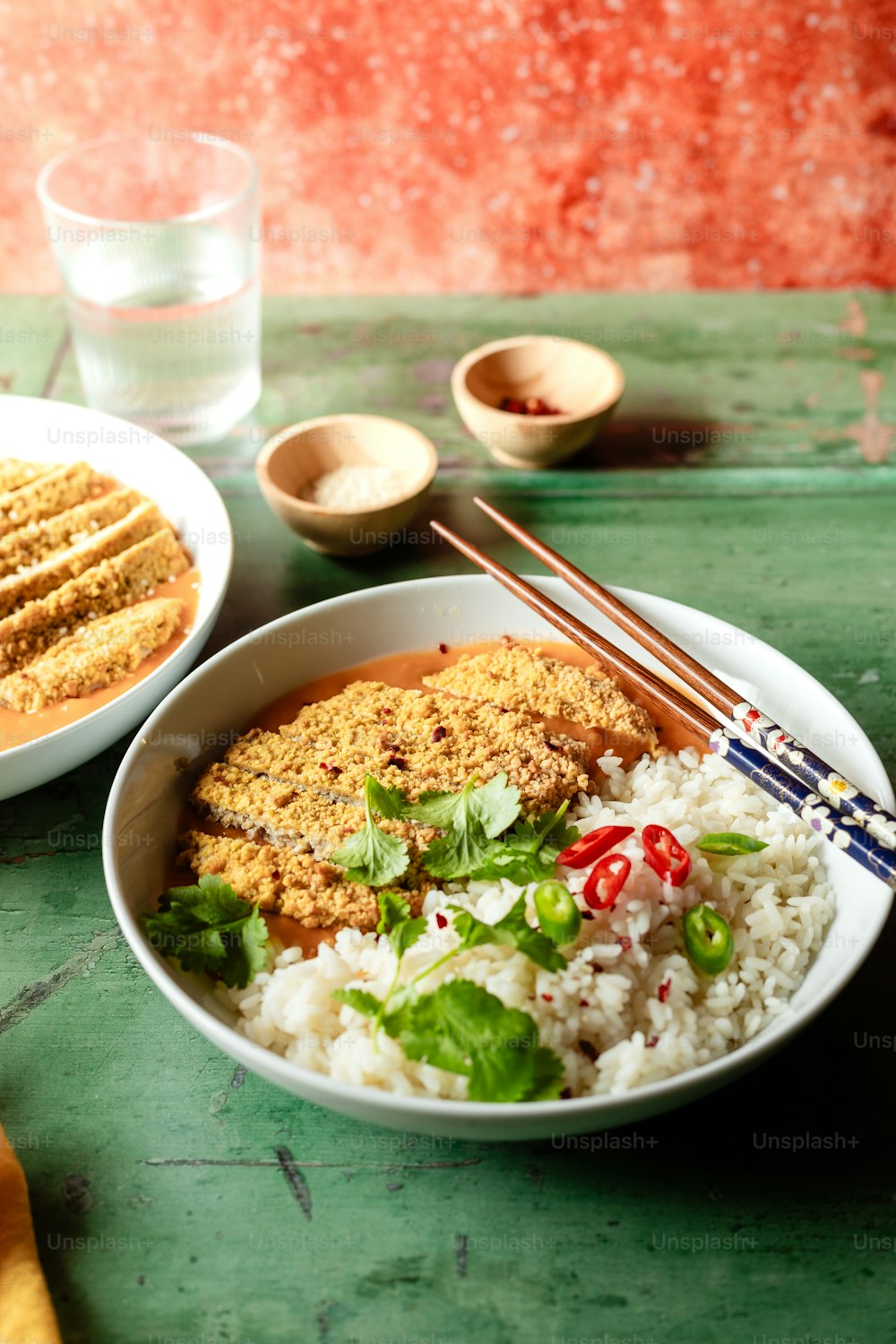 a bowl of food with chopsticks on a table