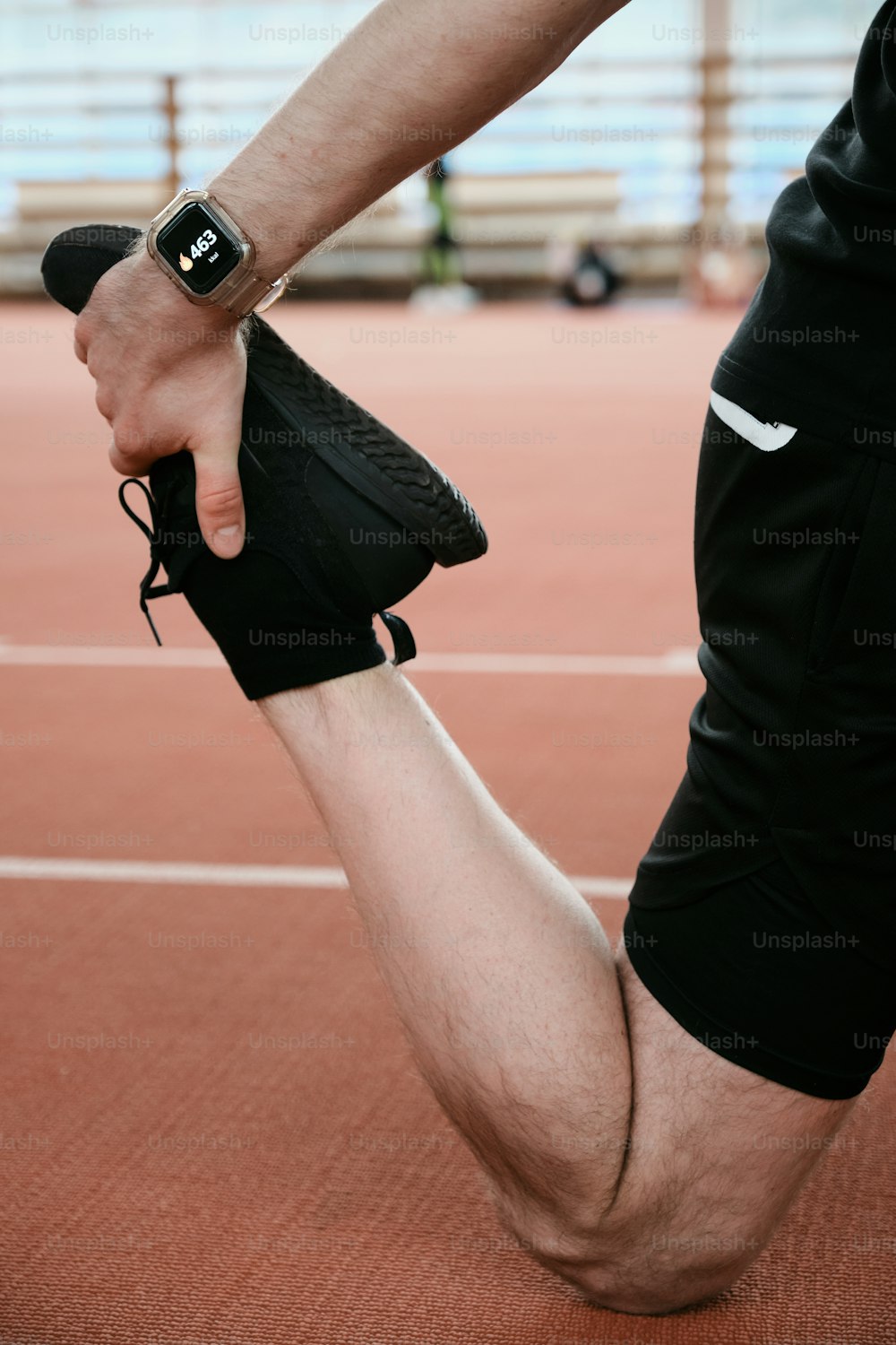 a person with a wristband holding a shoe