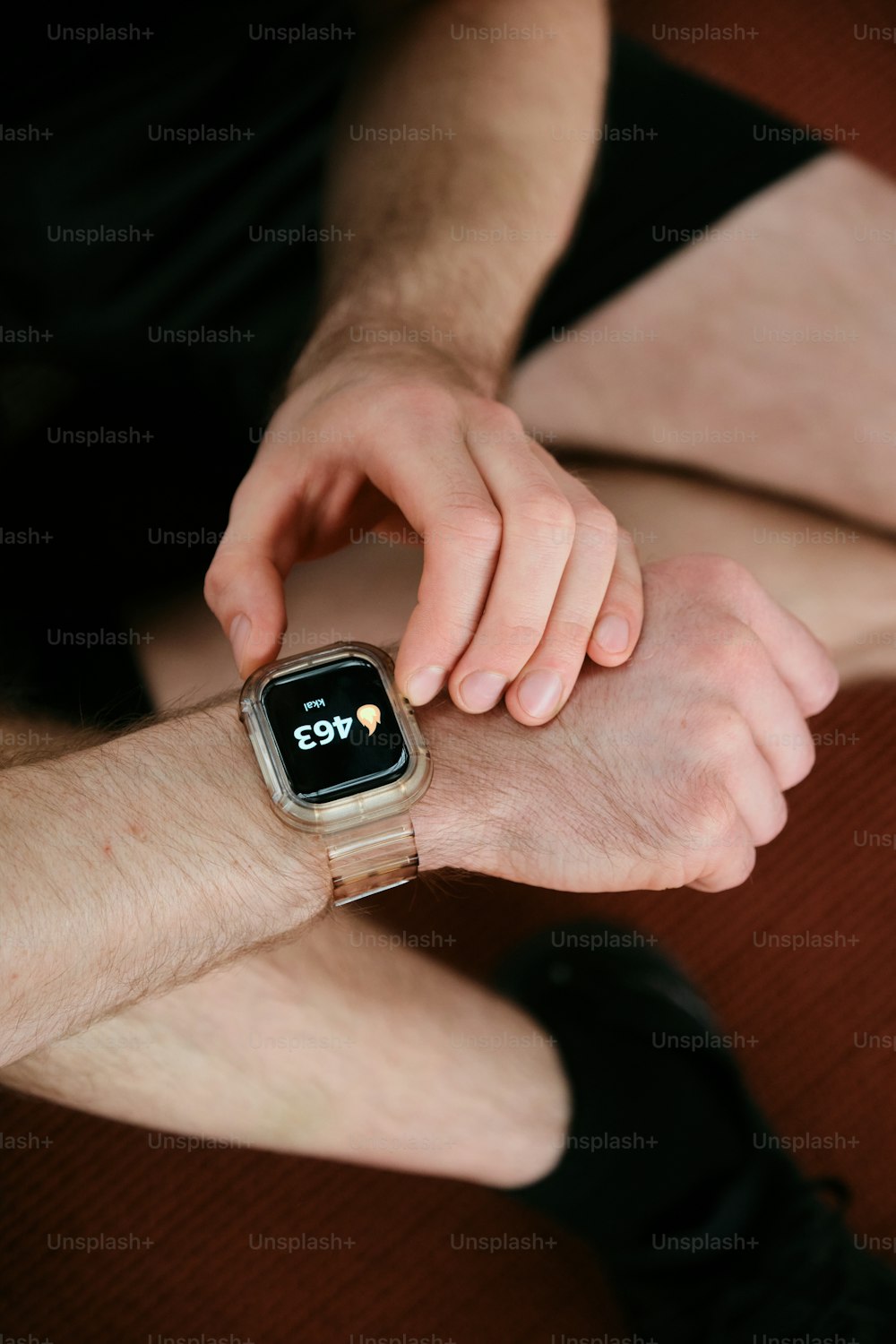 a man holding onto a smart watch on his arm