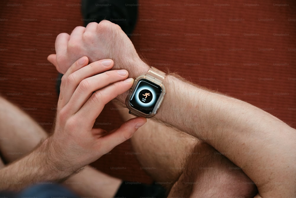 a man is holding his wrist with a watch on it