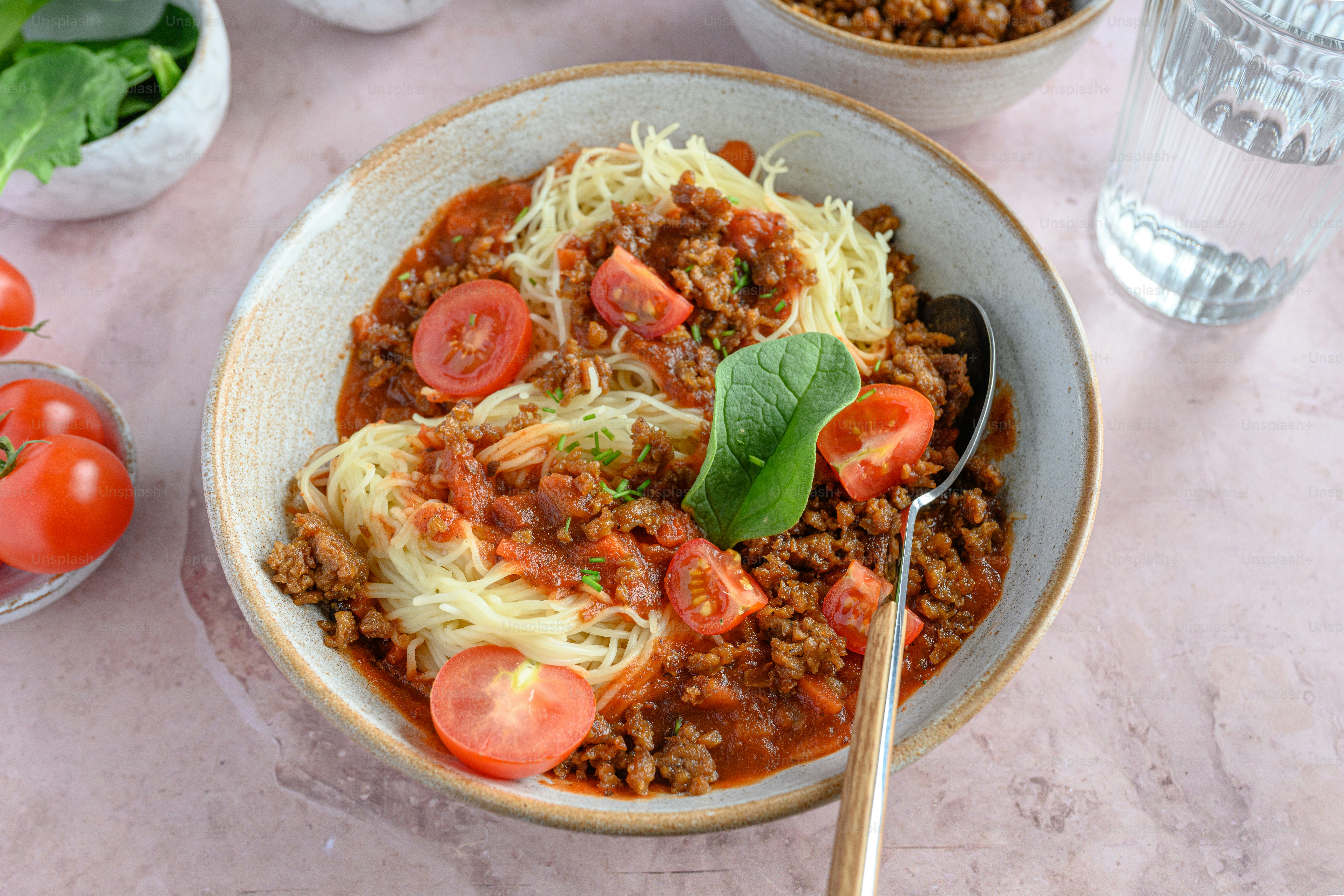 a bowl of spaghetti with meat and tomatoes