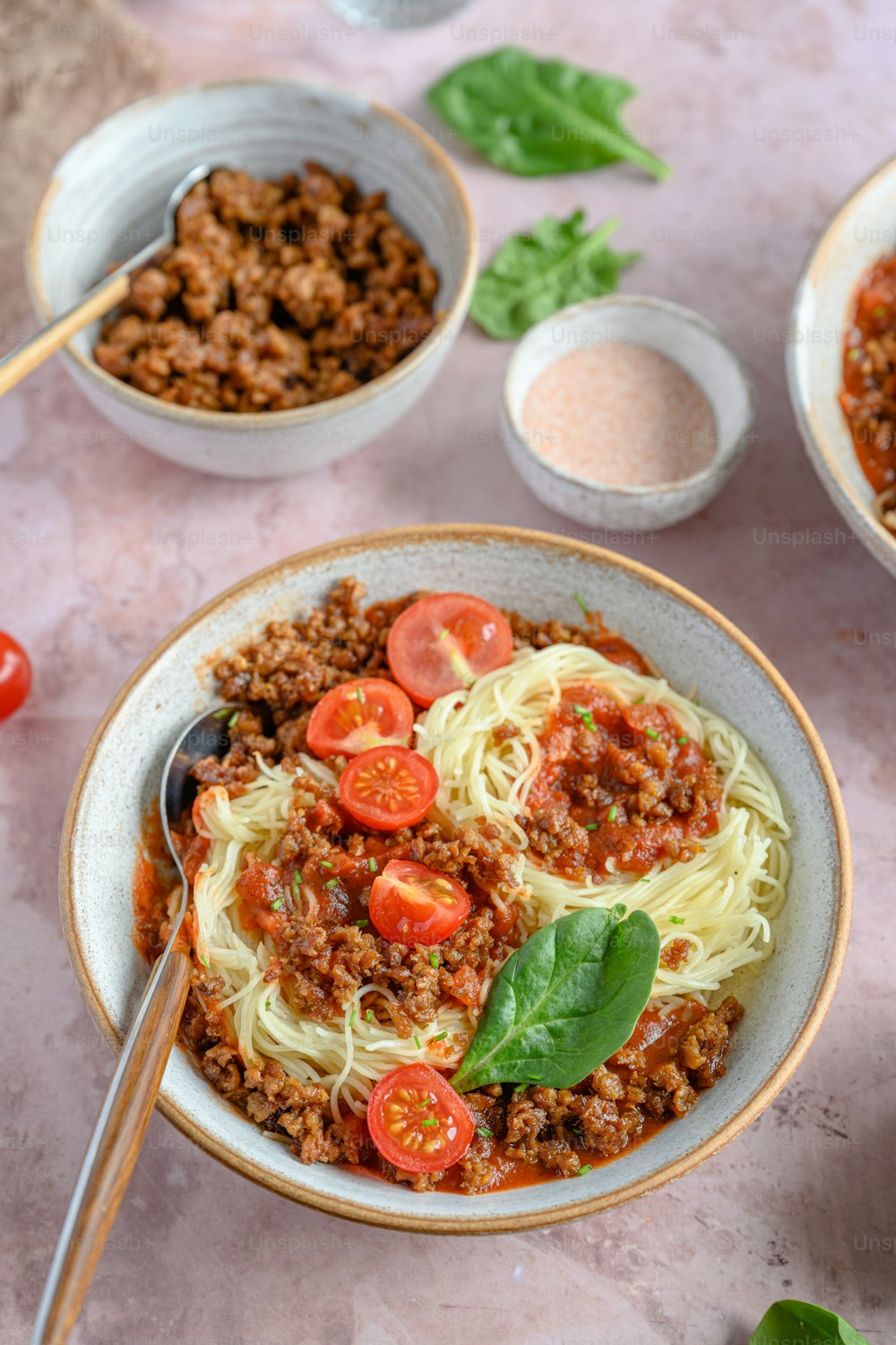 a bowl of spaghetti with meat and tomatoes