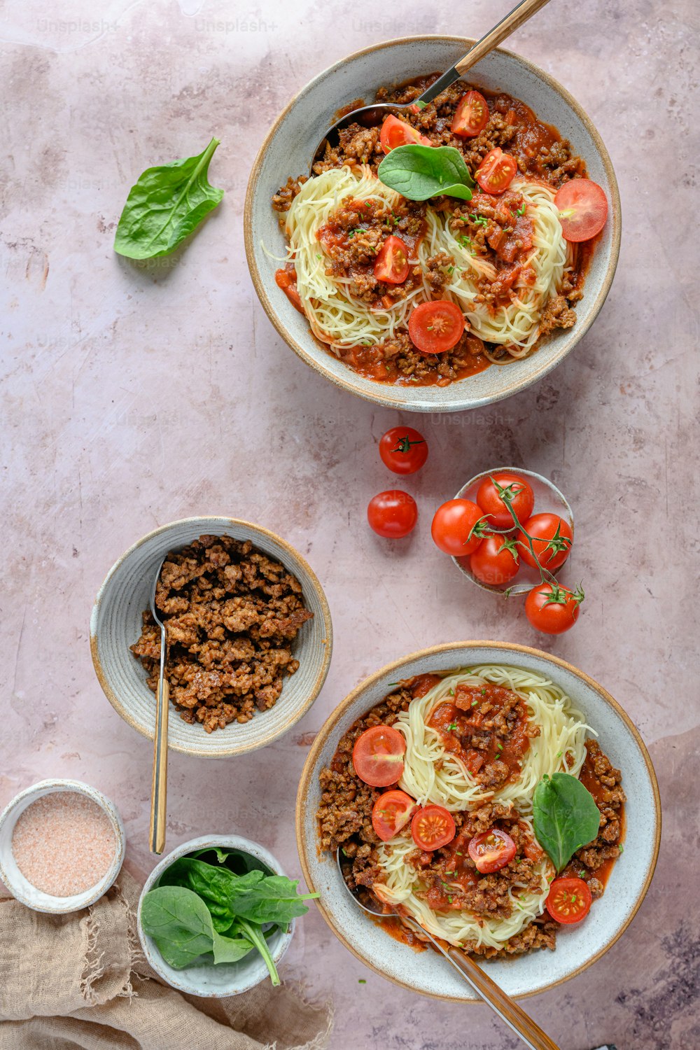 two bowls of spaghetti with meat and tomatoes