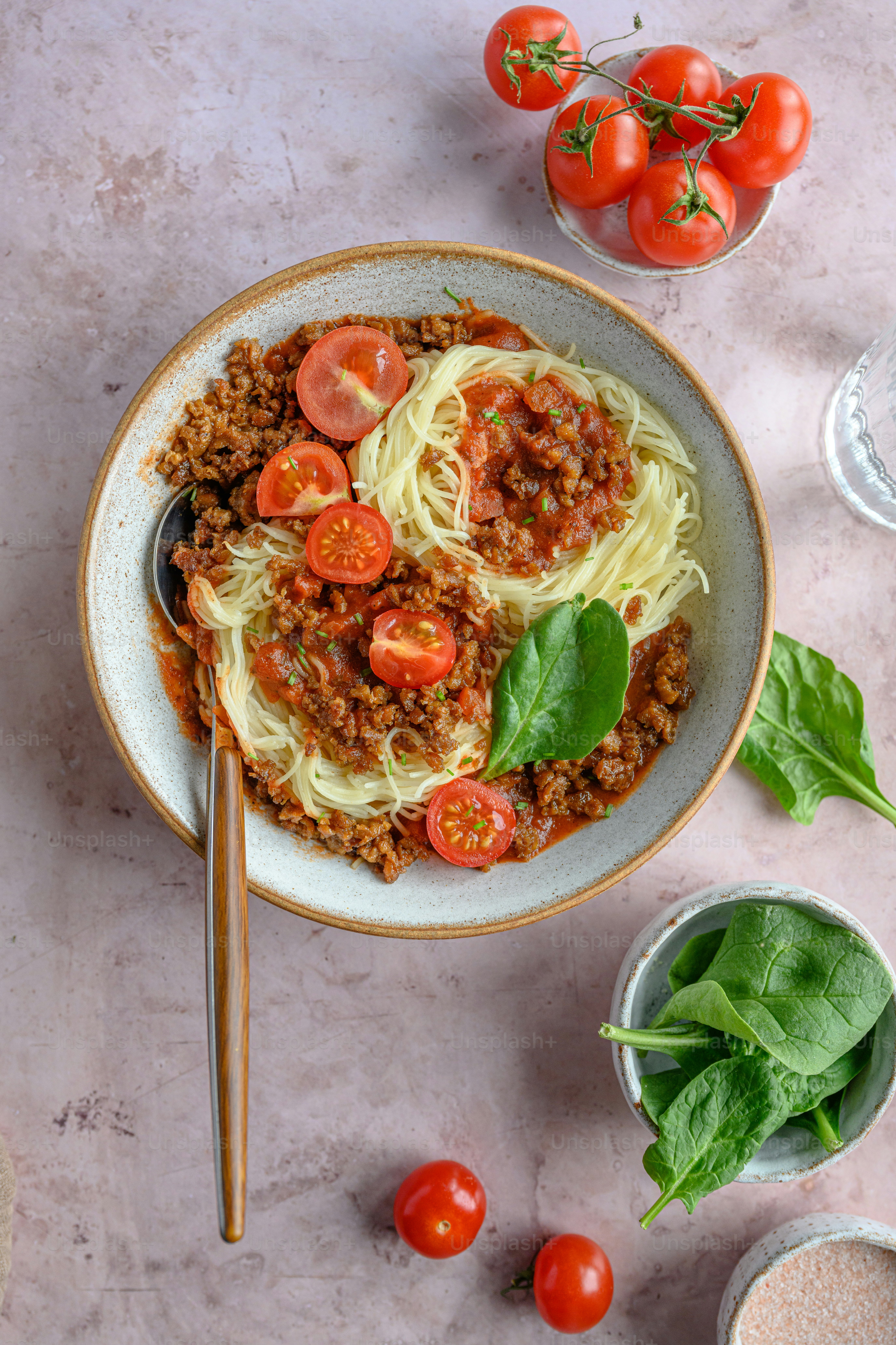 a bowl of spaghetti with meat and tomatoes