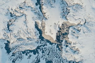 an aerial view of a snow covered mountain range