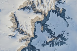 an aerial view of a snow covered mountain range